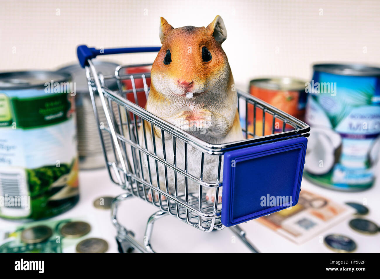 Hamster's figure in the shopping cart, symbolic photo hamster's purchases, Hamsterfigur im Einkaufswagen, Symbolfoto Hamsterkaeufe Stock Photo
