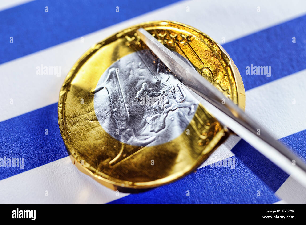 Scissors cut eurocoin, debt cut for Greece, Schere schneidet Euromuenze durch, Schuldenschnitt fuer Griechenland Stock Photo