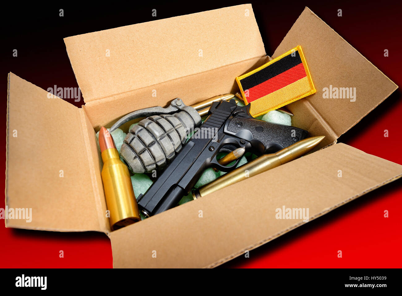 Package with weapons and Germany flag, symbolic photo German deliveries of arms, Paket mit Waffen und Deutschlandfahne, Symbolfoto deutsche Waffenlief Stock Photo