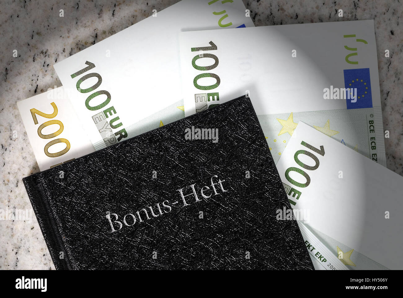 Bonus notebook with bank notes, bonus payments, Bonus-Heft mit Geldscheinen, Bonuszahlungen Stock Photo
