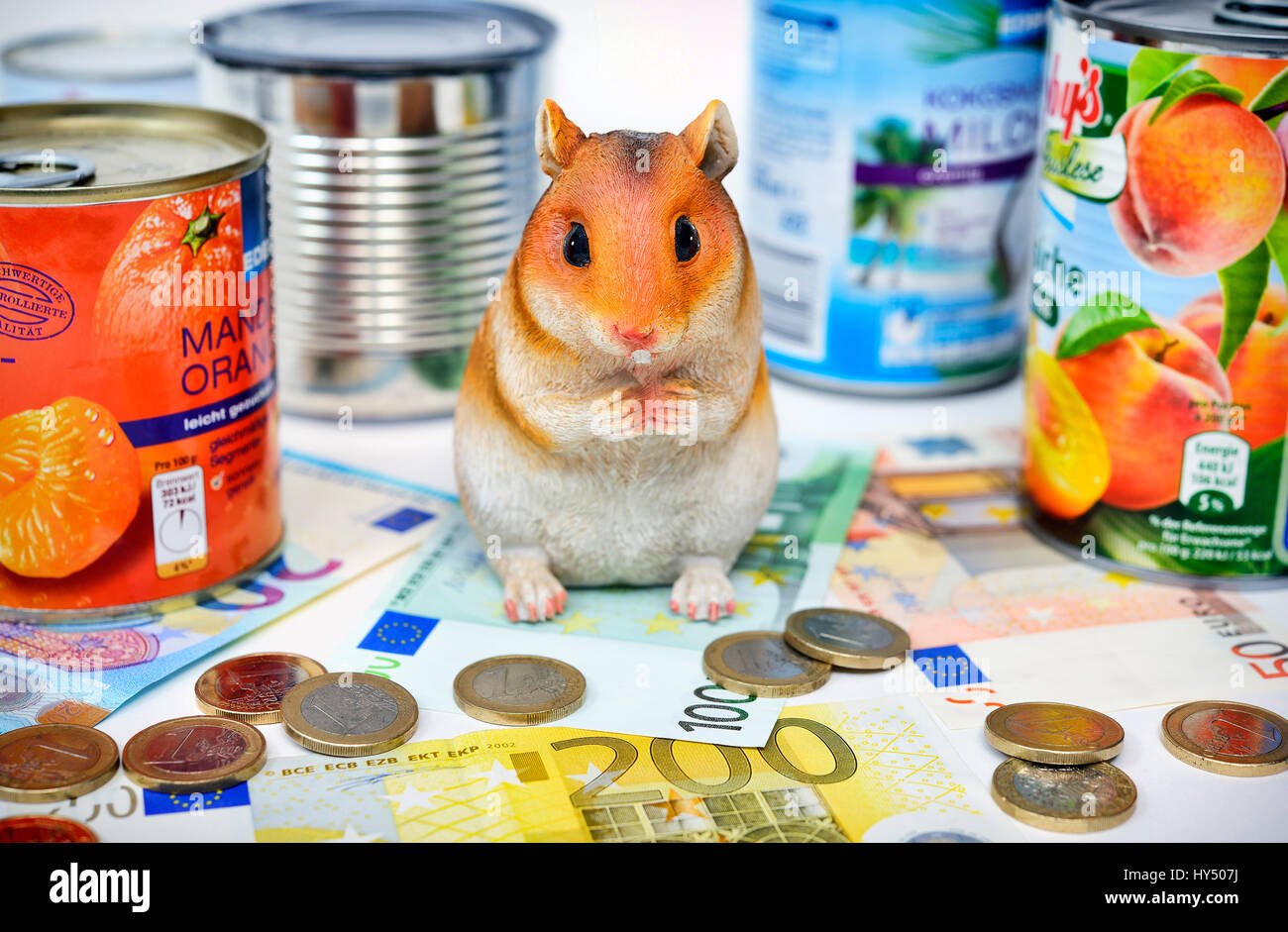 Hamster's figure with canned food tins, symbolic photo hamster's purchases, Hamsterfigur mit Konservendosen, Symbolfoto Hamsterkaeufe Stock Photo
