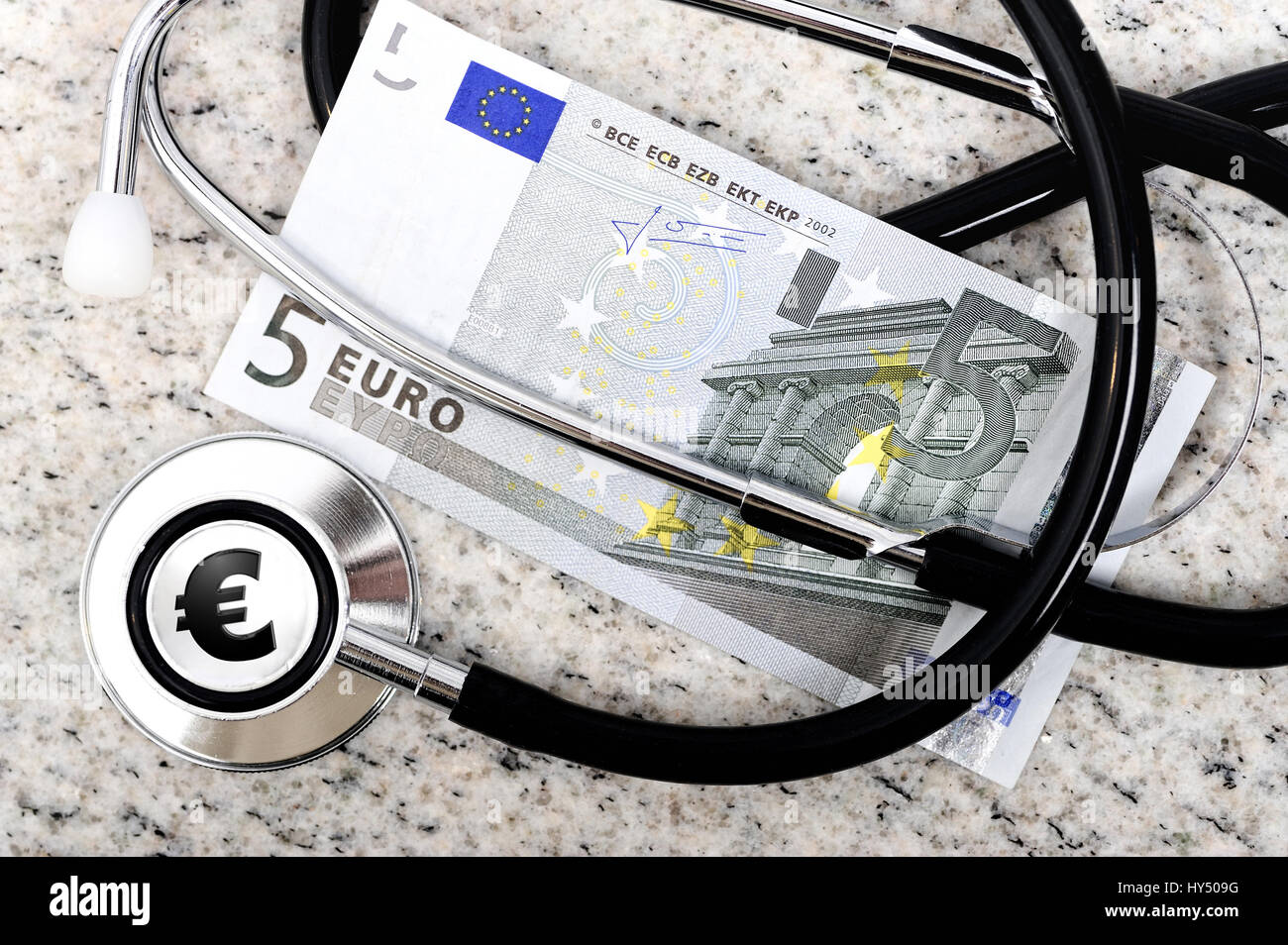 Arzt-Stethoskop and Fuenf-euro-light, payment of five euros per doctor's visit, Arzt-Stethoskop und Fuenf-Euro-Schein, Bezahlung von fuenf Euro pro Ar Stock Photo