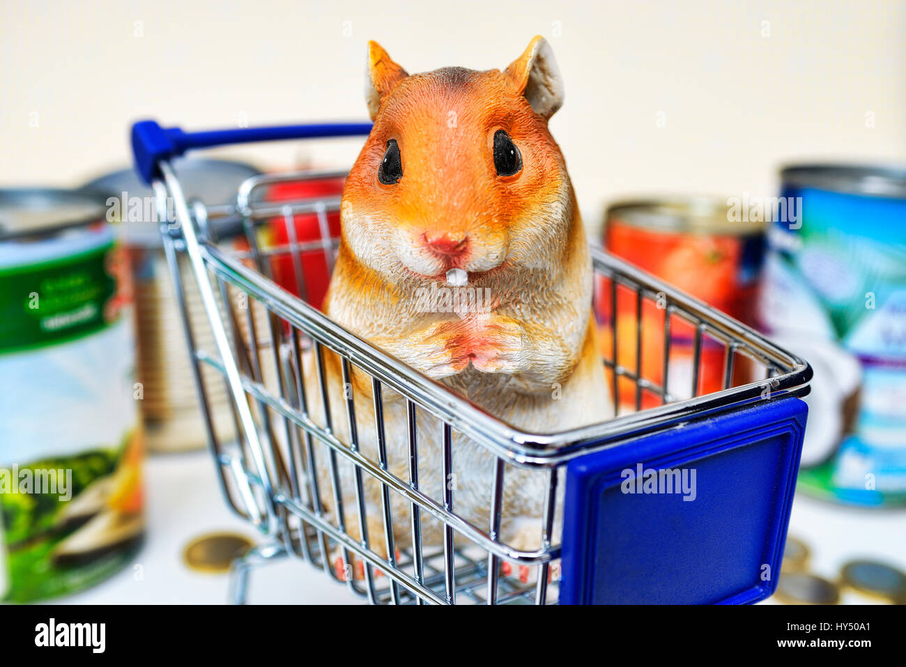 Hamster's figure in the shopping cart, symbolic photo hamster's purchases, Hamsterfigur im Einkaufswagen, Symbolfoto Hamsterkaeufe Stock Photo