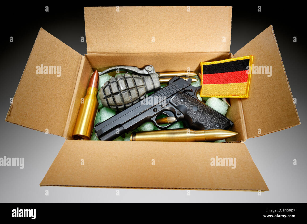 Package with weapons and Germany flag, symbolic photo German deliveries of arms, Paket mit Waffen und Deutschlandfahne, Symbolfoto deutsche Waffenlief Stock Photo