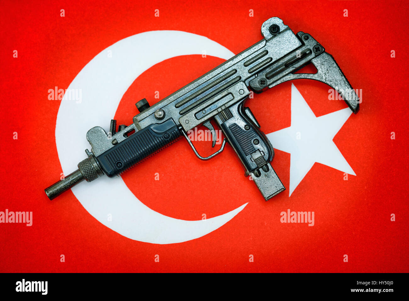 Submachine gun on Turkish flag, symbolic photo for the reproach of the