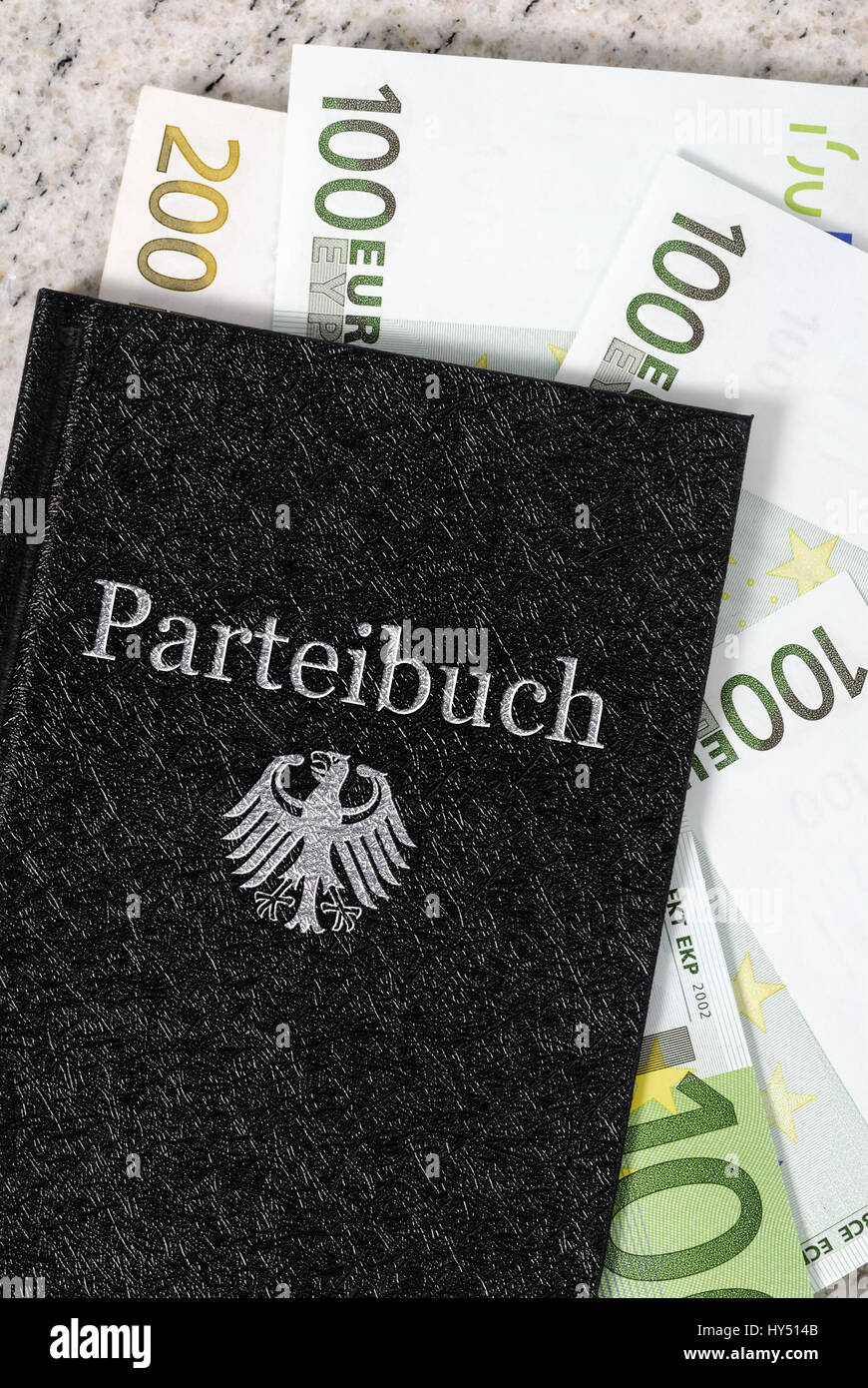Party card with bank notes, income and additional incomes of politicians, Parteibuch mit Geldscheinen, Einkuenfte und Nebeneinkuenfte von Politikern Stock Photo