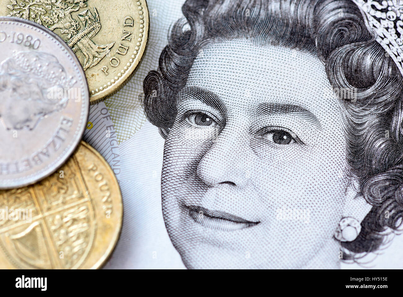 Portrait of queen Elizabeth II on a British Fuenf pound mark and pound coins, Portrait von Queen Elizabeth II. auf einer britischen Fuenf-Pfund-Note u Stock Photo