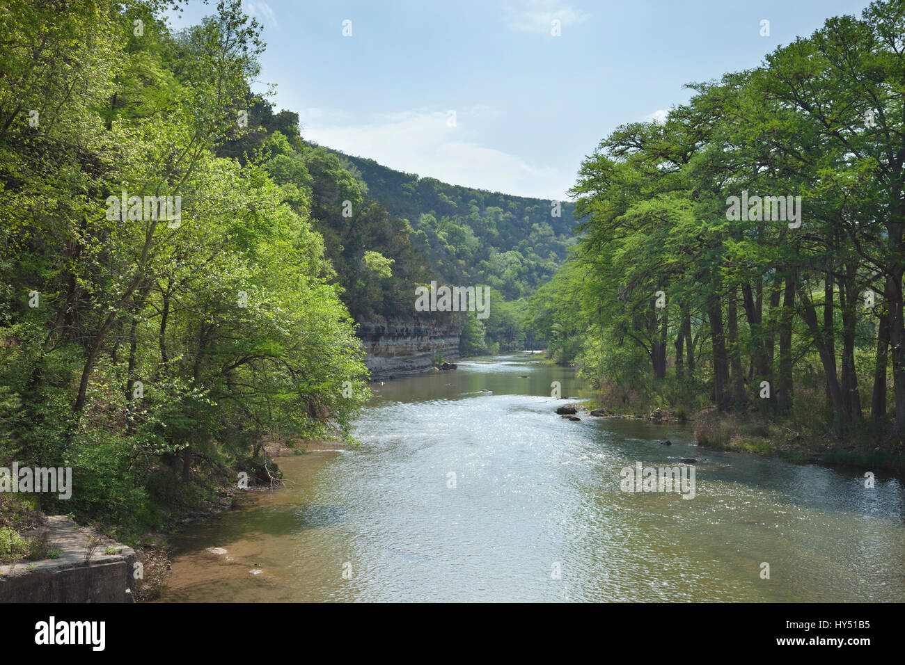 The Guadalupe River below cliffs of the Texas Hill Country during Spring Stock Photo