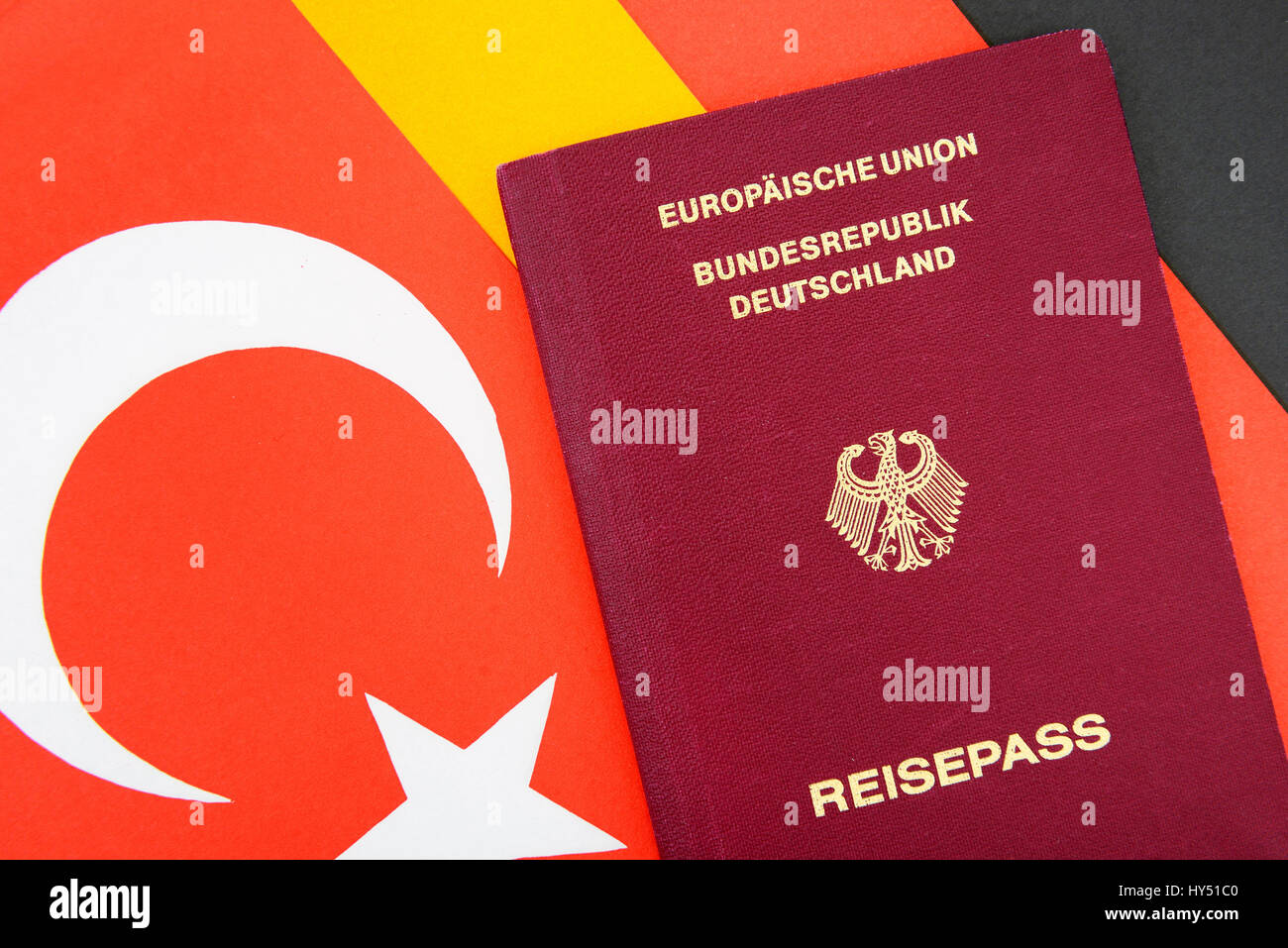 German passport on Turkey and Germany flag, double citizenship, Deutscher Reisepass auf Tuerkei