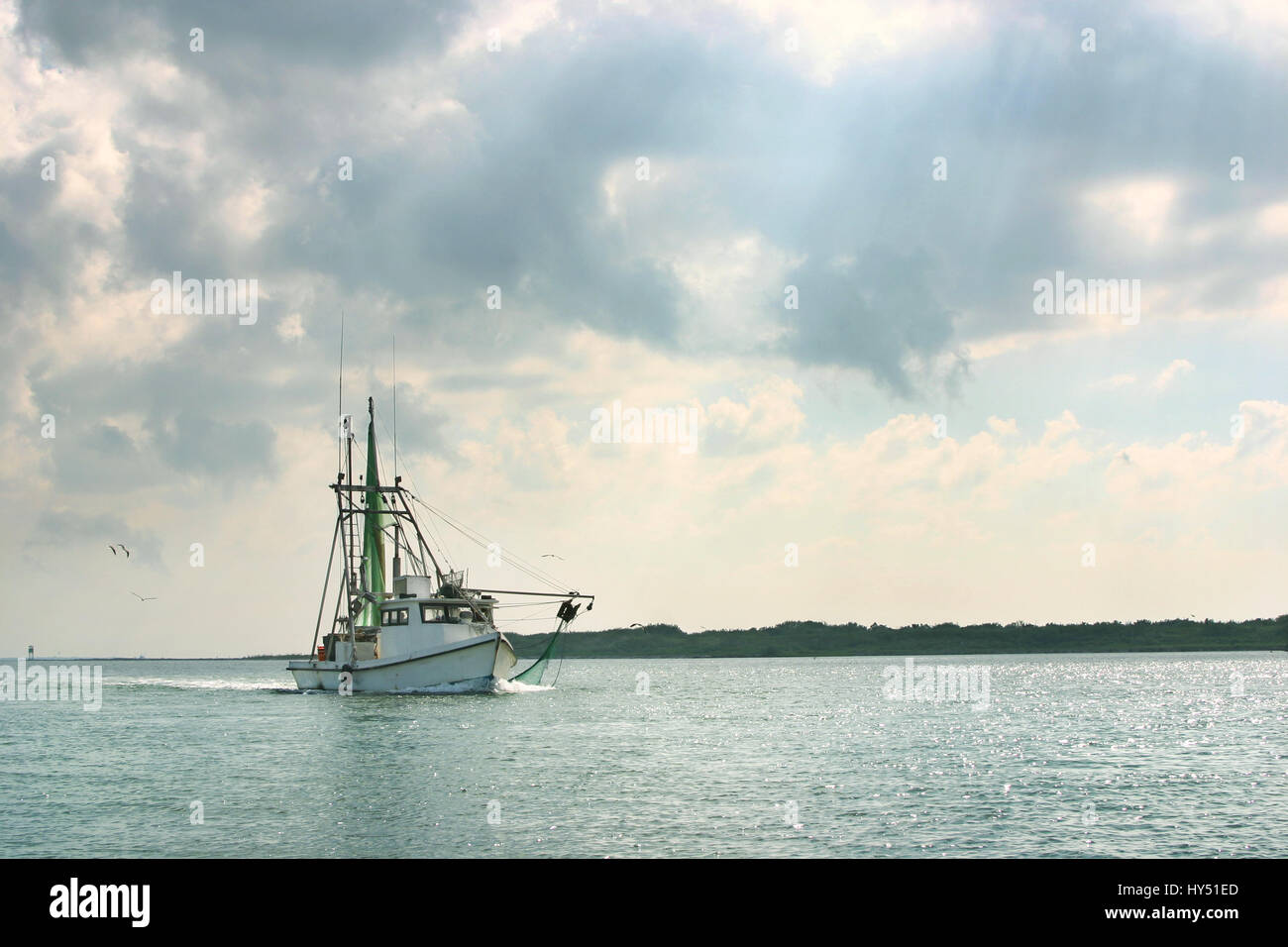 A shrimp boat on the gulf coast in Texas returns to port after a day of fishing Stock Photo