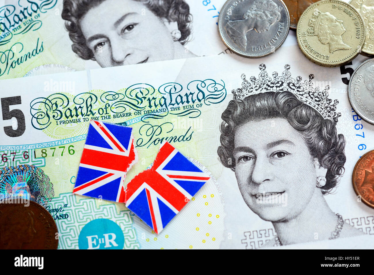 British pound marks and torn flag of Great Britain, symbolic photo Brexit, Britische Pfundnoten und zerrissene Fahne von Gro?britannien, Symbolfoto Br Stock Photo