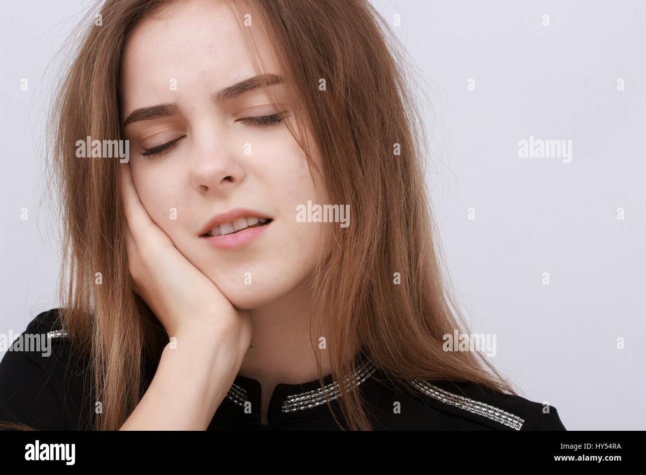 Woman has toothache coppy space Isolated on white background. Stock Photo
