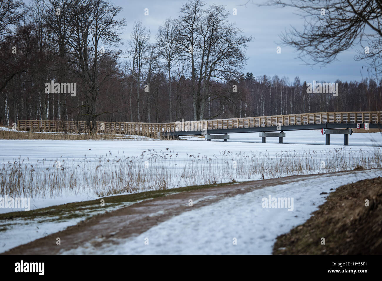 A beautiful winter landscape with a bridge over the frozen river Stock ...