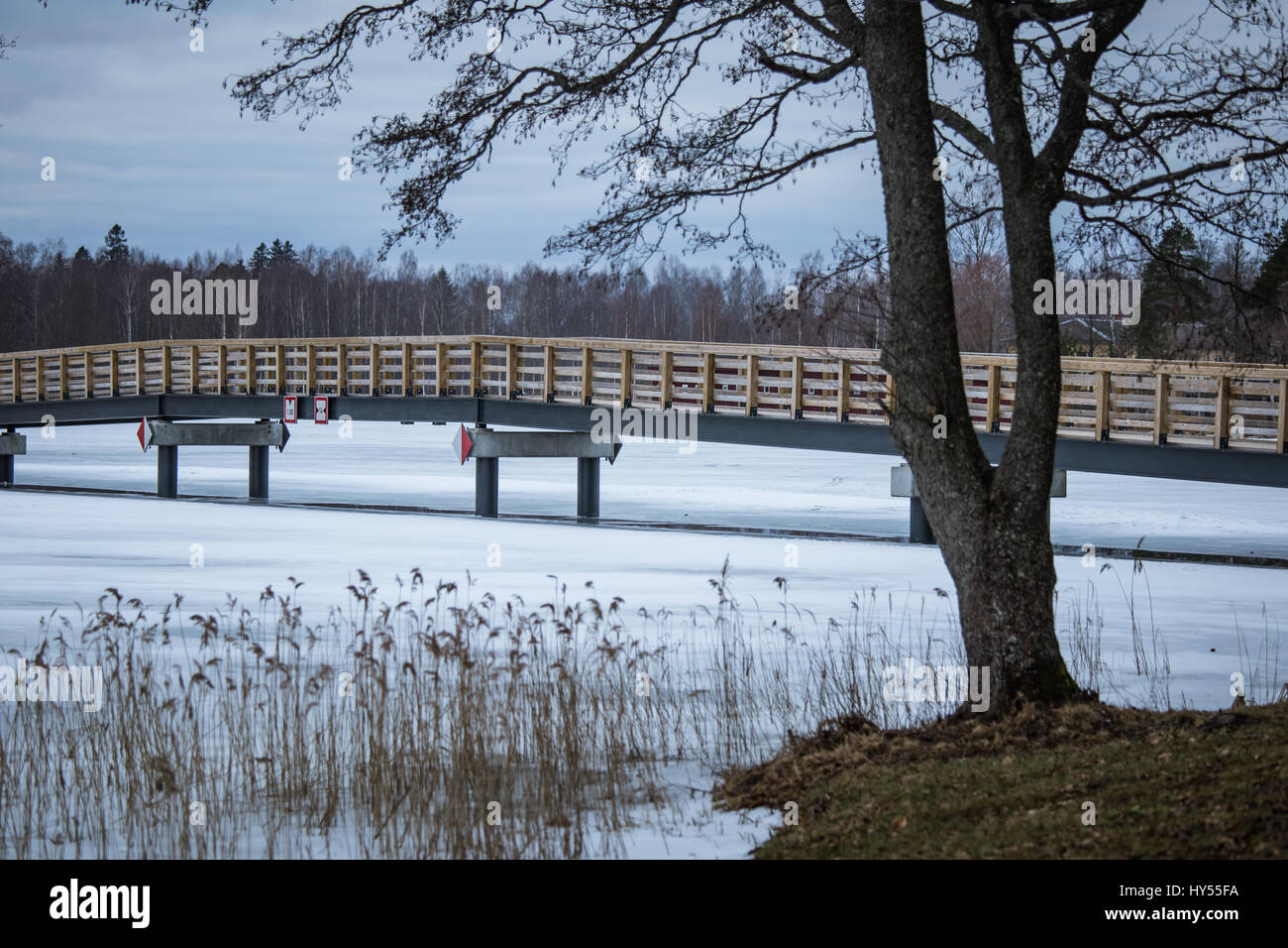 A beautiful winter landscape with a bridge over the frozen river Stock ...