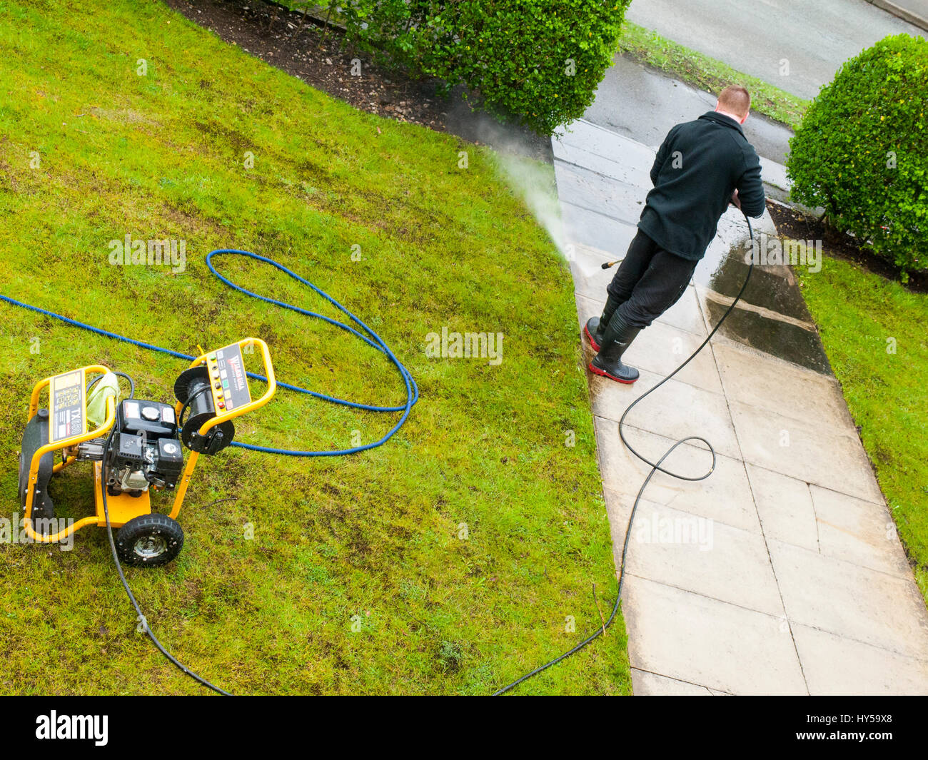 Cleaning footpath using high pressure washer Stock Photo Alamy