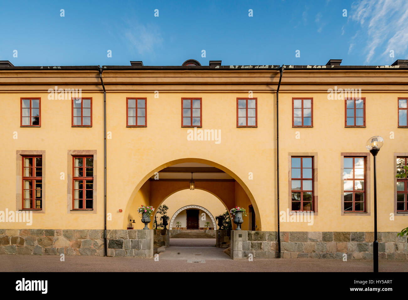 Sweden, Uppland, Uppsala, Arched entrance of yellow building in Linnean Gardens of Uppsala Stock Photo
