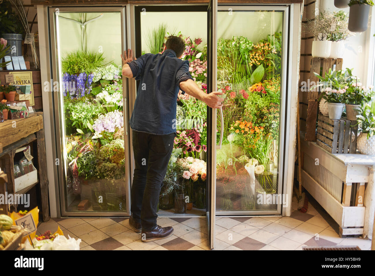 Florist opening door in flower shop hires stock photography and images