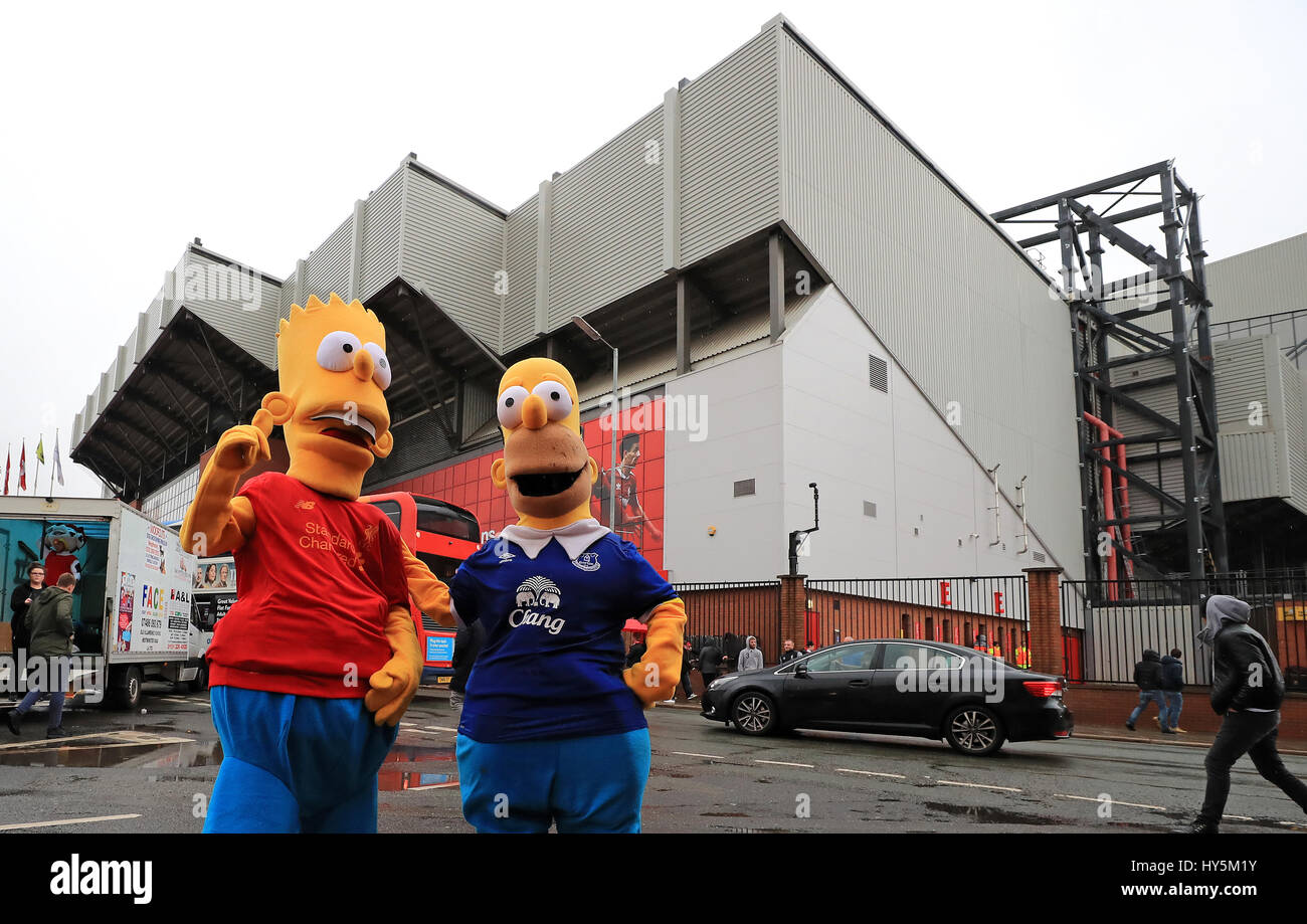 Fans dressed as Bart and Homer Simpson before the Premier League match at Anfield, Liverpool. Stock Photo