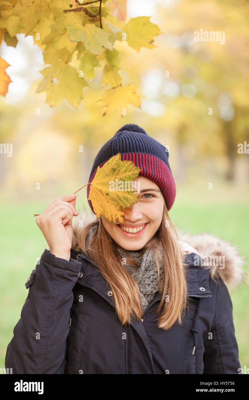 Woman with autumn leaf in front of an eye Stock Photo - Alamy