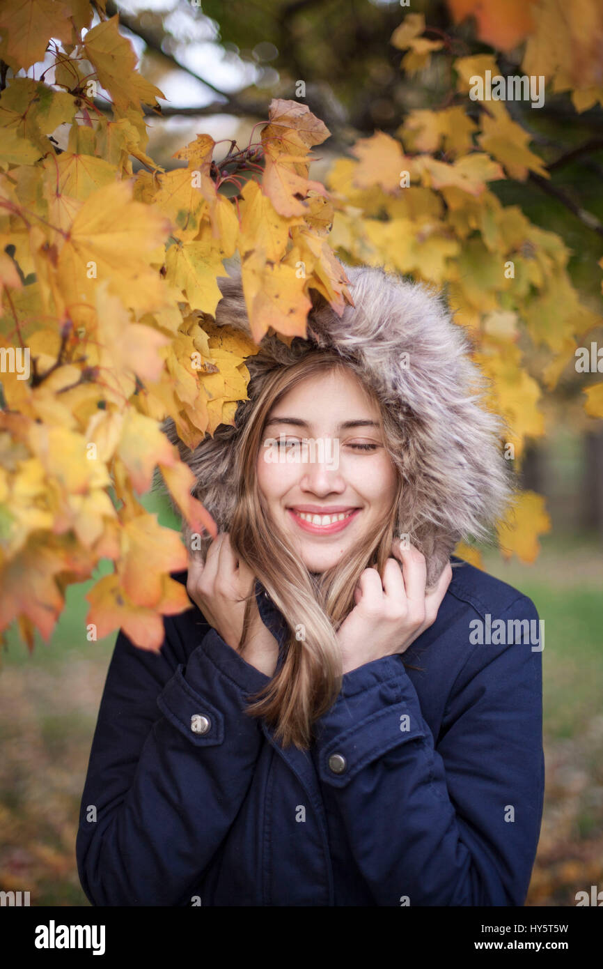 Portrait of a young woman between autumn leaves Stock Photo - Alamy