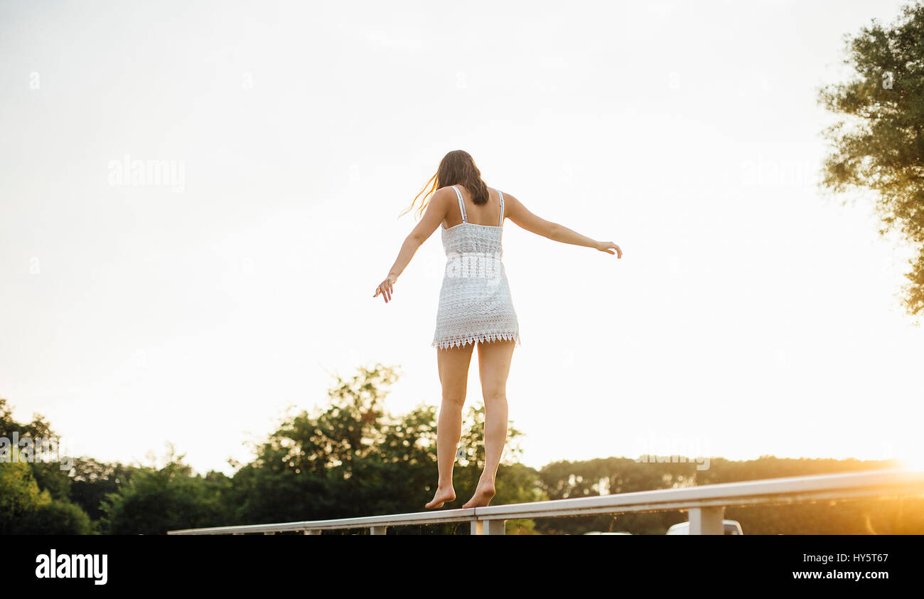 Balancing On Railing Young woman balances on railings Stock Photo - Alamy