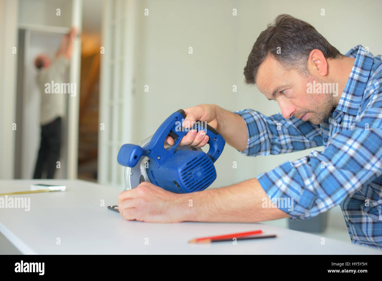 Carpenter cutting a straight line using a band saw Stock Photo Alamy