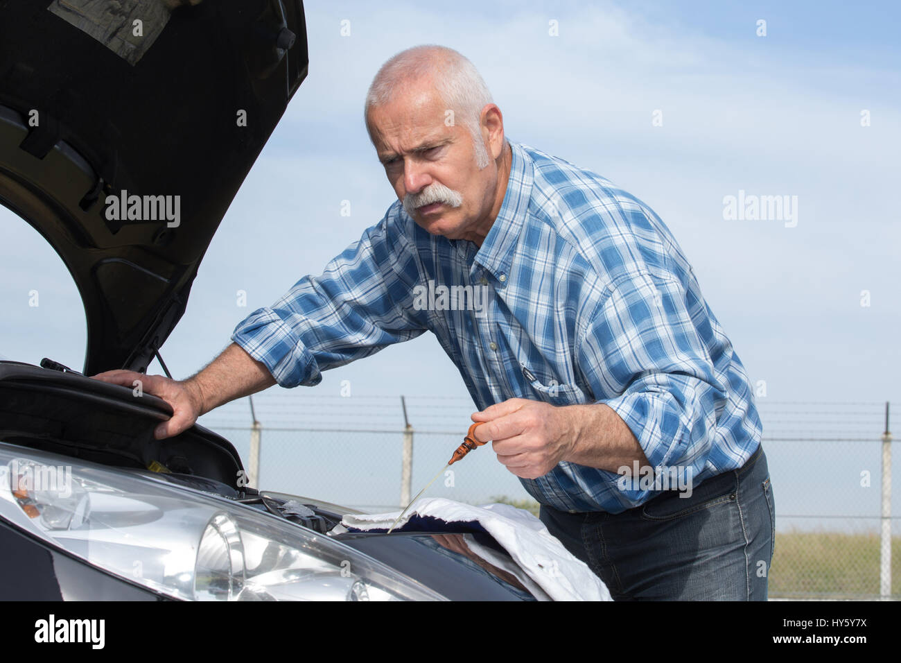 senior man checking car motor levels Stock Photo - Alamy