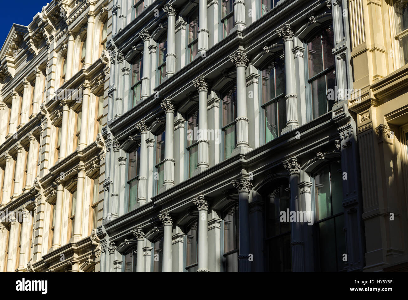 Painted 19th century facades in Manhattan's Soho neighborhood with cast iron columns and ornamentation. New York City Stock Photo