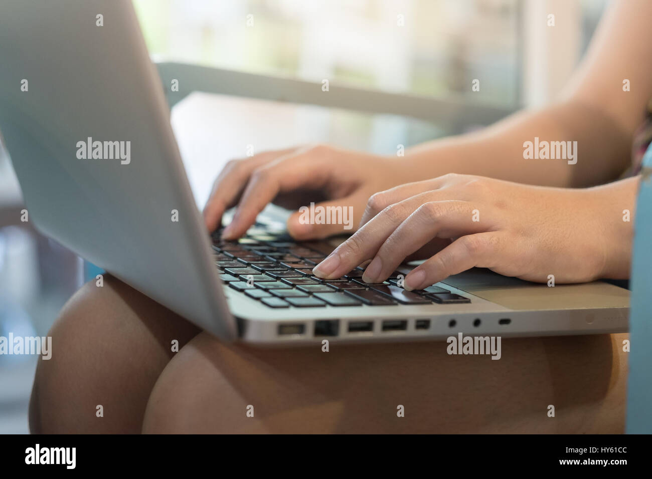 Woman hand typing on laptop computer keyboard for online business. work from anywhere concept Stock Photo
