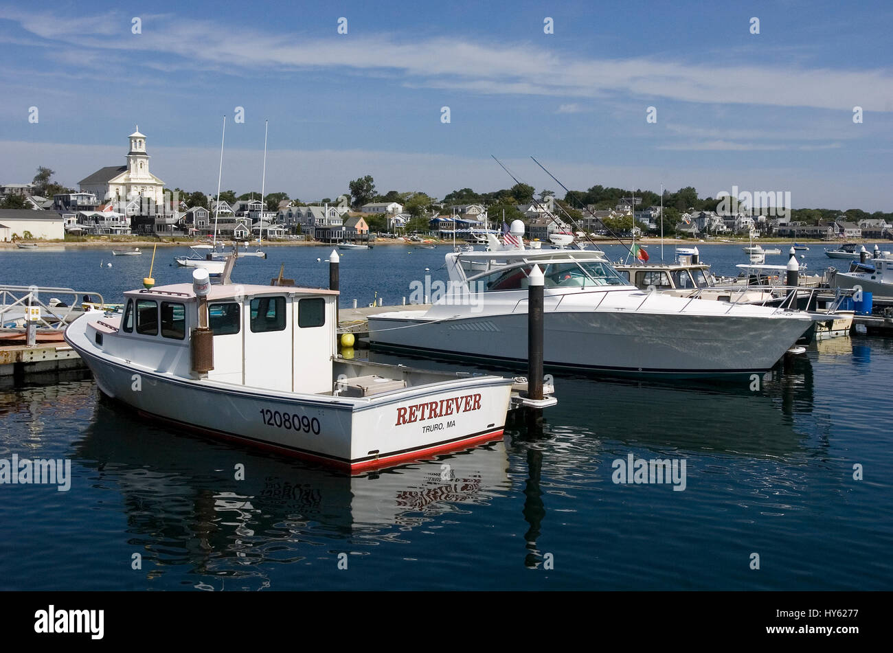 The Provincetown waterfront and boats docked at Macmillan Pier.   The tall building on the waterfront is the newly refurbished town library Stock Photo