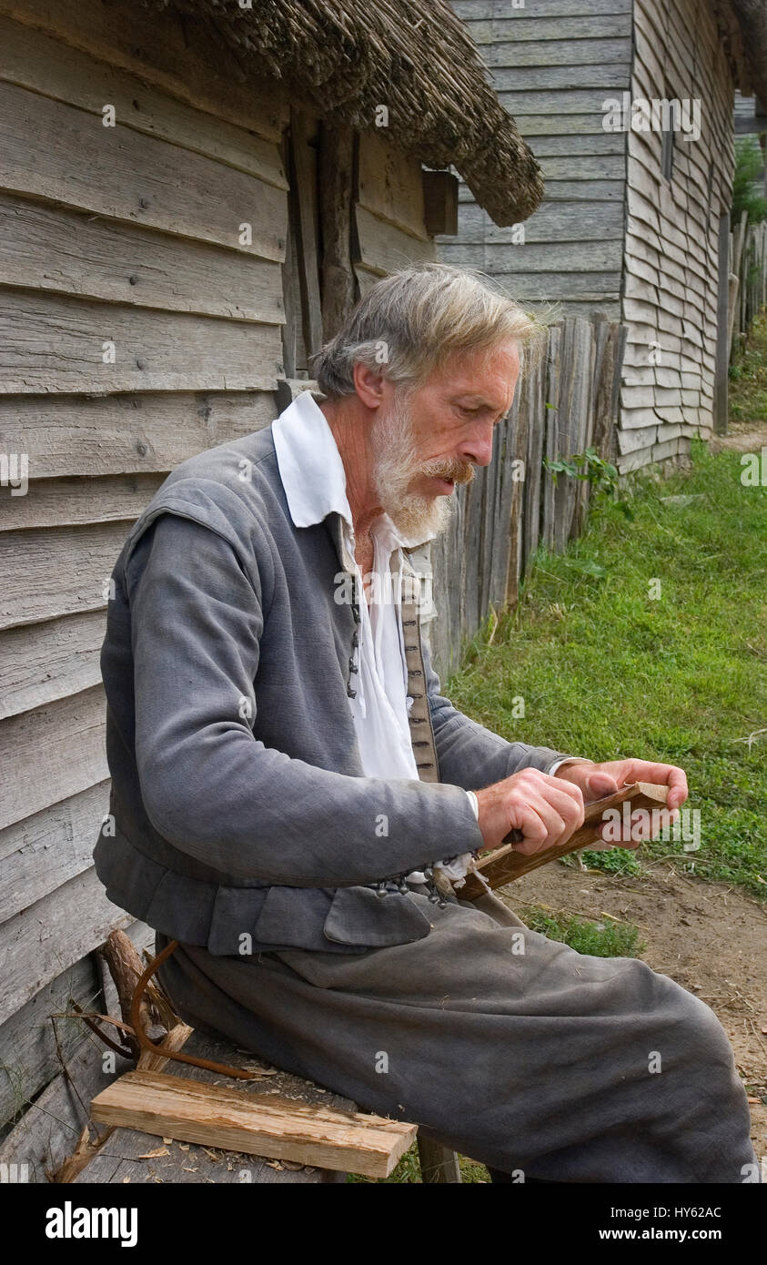 A Pilgrim outside his home in Plimoth Plantation -- (released through Plimoth Plantation), Plymouth, Massachusetts. Now known as Plimoth Pataxet Stock Photo