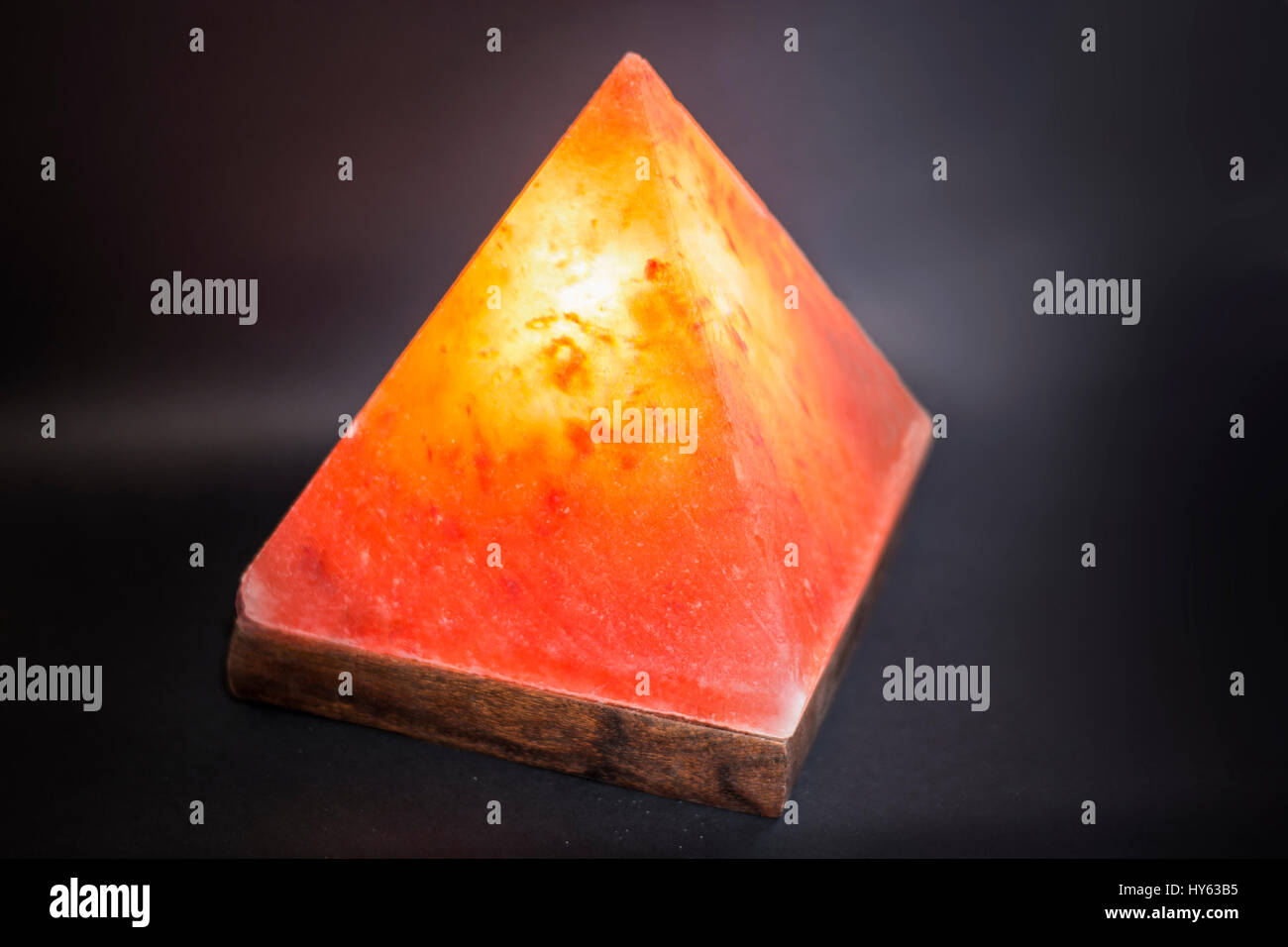 Glowing pyramid of red salt lamp Stock Photo Alamy