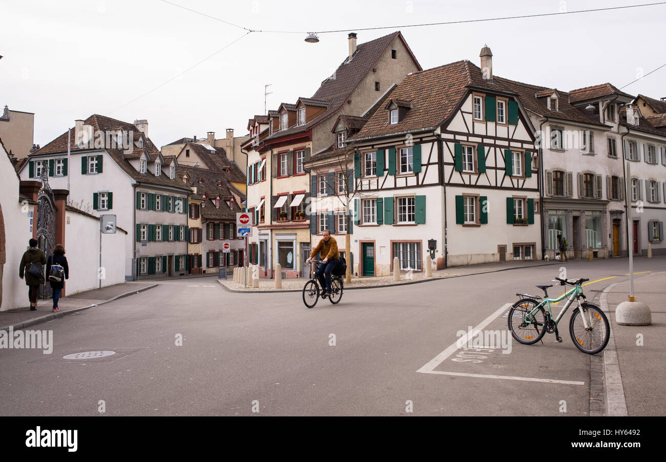 Man cycling in Utengasse in Basel old town (Altstadt Kleinbasel) with traditional Swiss medieval houses. Switzerland. Stock Photo