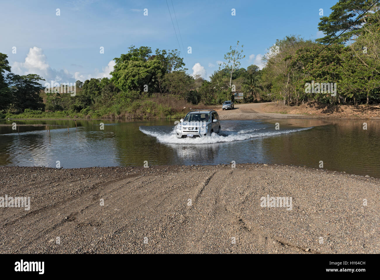Car at a river crossing near Drake, Costa Rica Stock Photo
