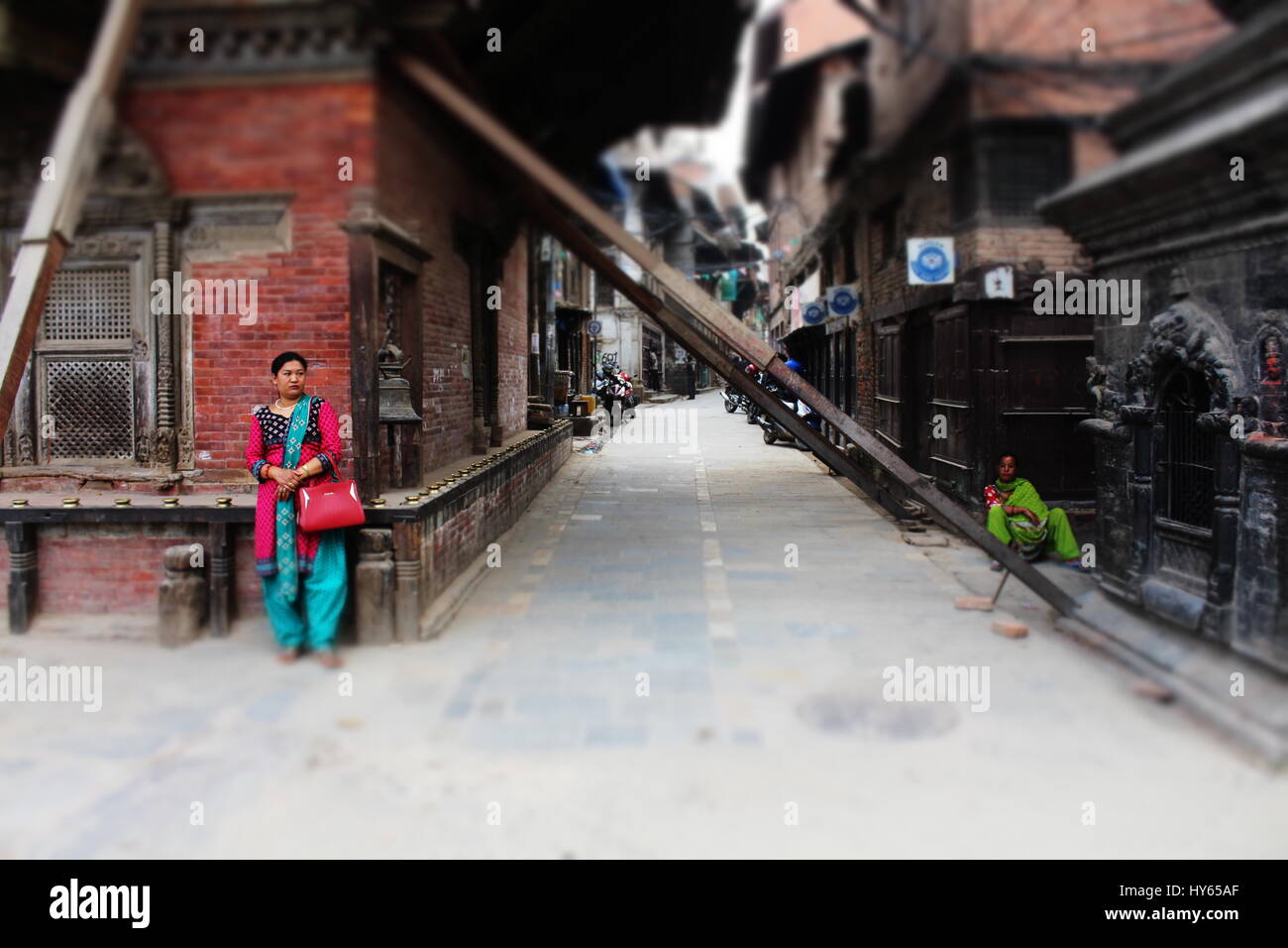 Two women in the street of Patan Durbar Square. We can see the difference between high class women and low class women. Stock Photo