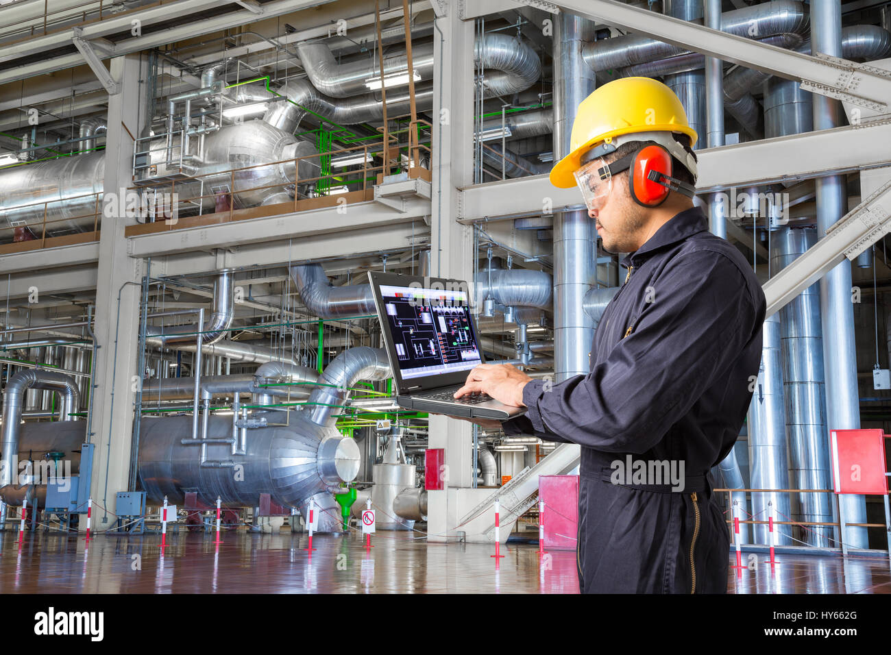 Engineer using laptop computer for maintenance equipment and pipeline ...