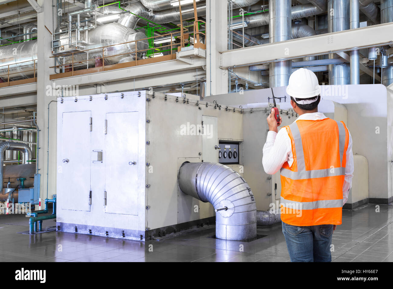 Engineer working in the thermal power plant with talking on the walkie