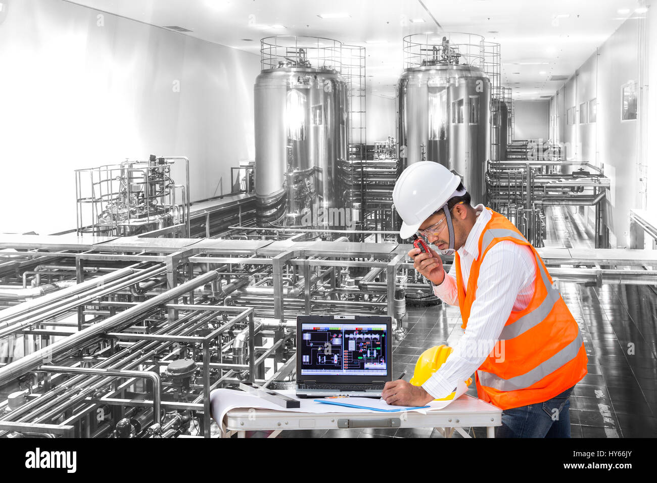 Industrial engineer checking machine status with laptop computer Stock