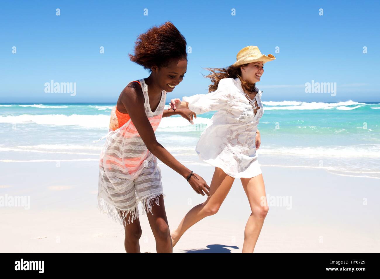 Two girls running holding hands hi-res stock photography and images - Alamy