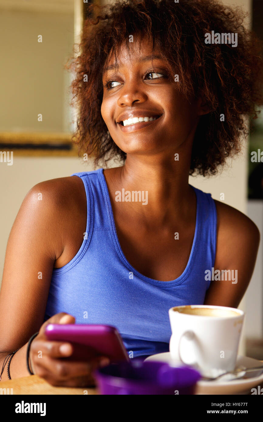 Laughing young african woman typing hi-res stock photography and images ...