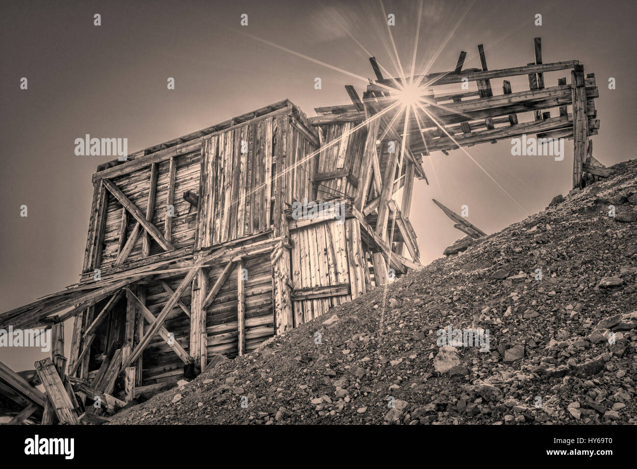ruins of gold mine near Mosquito Pass in Rocky Mountains, Colorado - upper station of aerial tramway used to transport gold ore, retro sepia toning wi Stock Photo