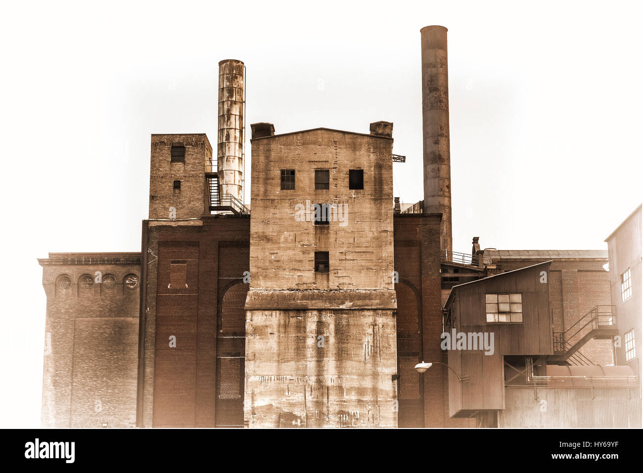 old power plant building with brick, concrete and metal walls, retro sepia toning Stock Photo