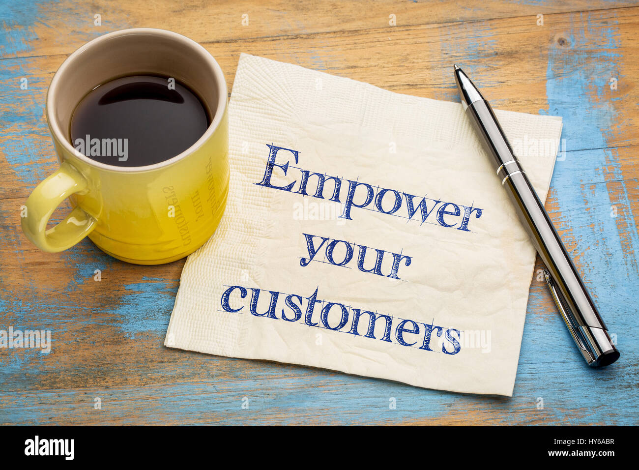 Empower your customers advice or reminder - handwriting on a napkin with a cup of espresso coffee Stock Photo