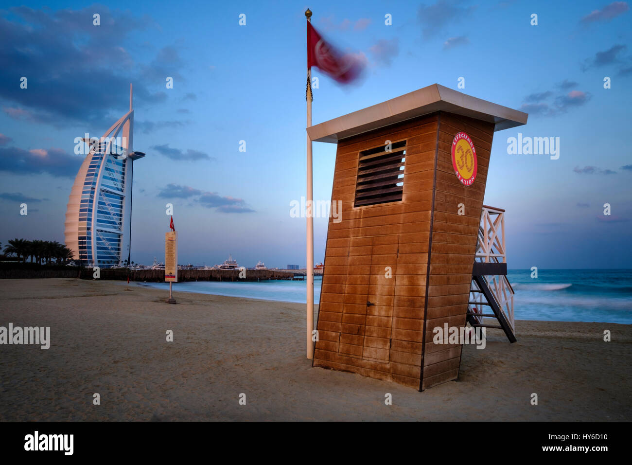 UNITED ARAB EMIRATES, DUBAI - CIRCA JANUARY 2017:  Lifeguard station at the Jumeirah Public Beach at sunrise. with view of the Burj Al Arab, the only  Stock Photo