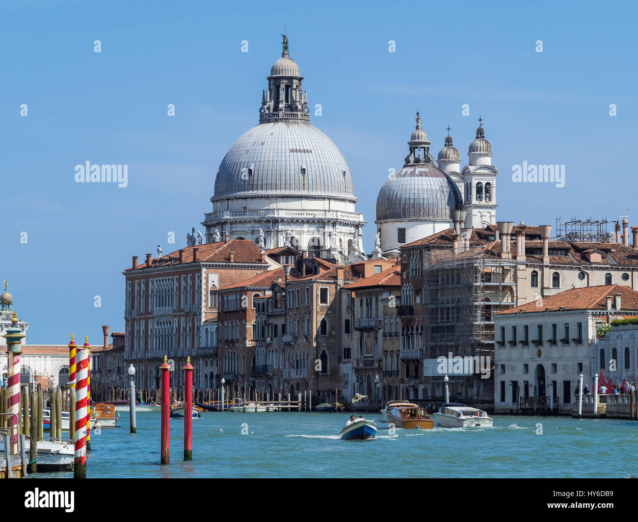 Basilica di Santa Maria della Salute from the Grand Canal with boats and blue sky, Venice, Italy Stock Photo