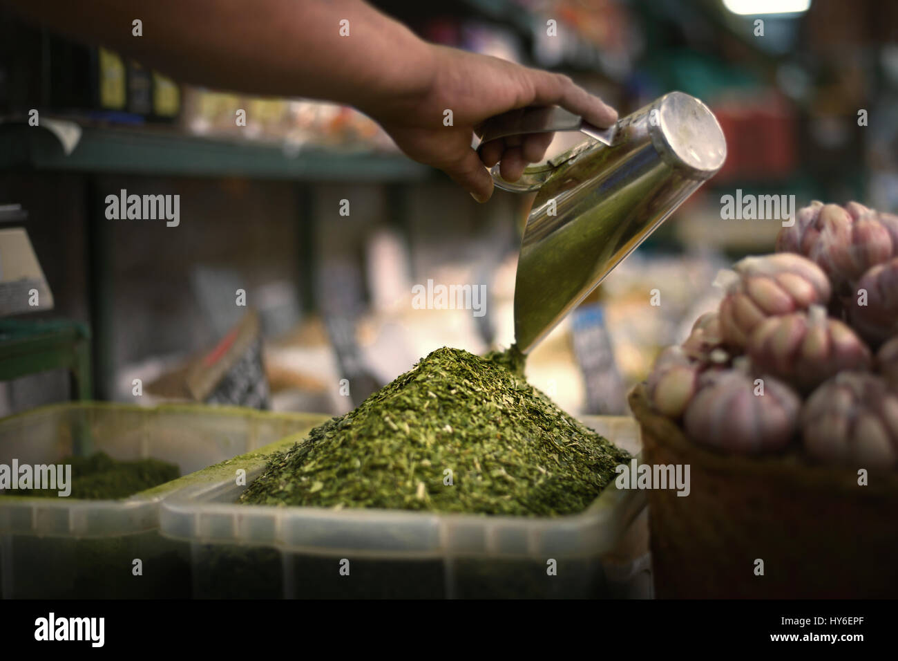 Owner of the market preparing mate for sale. Stock Photo
