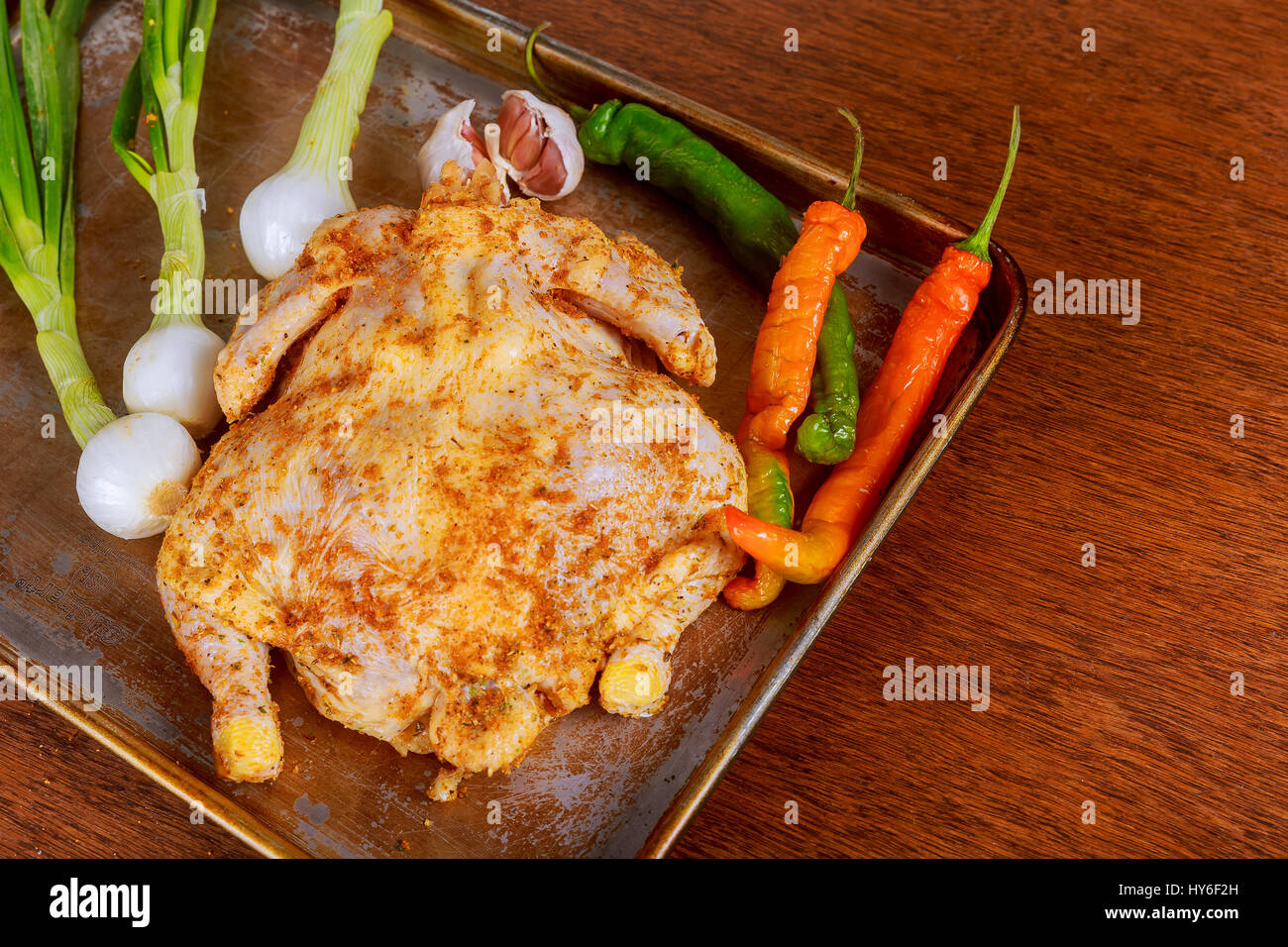 A marinated chicken cooking in a slow cooker. marinated whole chicken