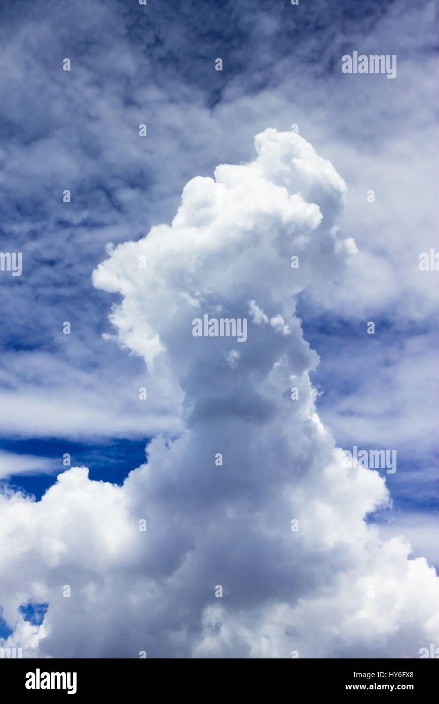 Small sized towering cumulus clouds with cirrocumulus clouds on background as seen on the sky over Jakarta. Stock Photo
