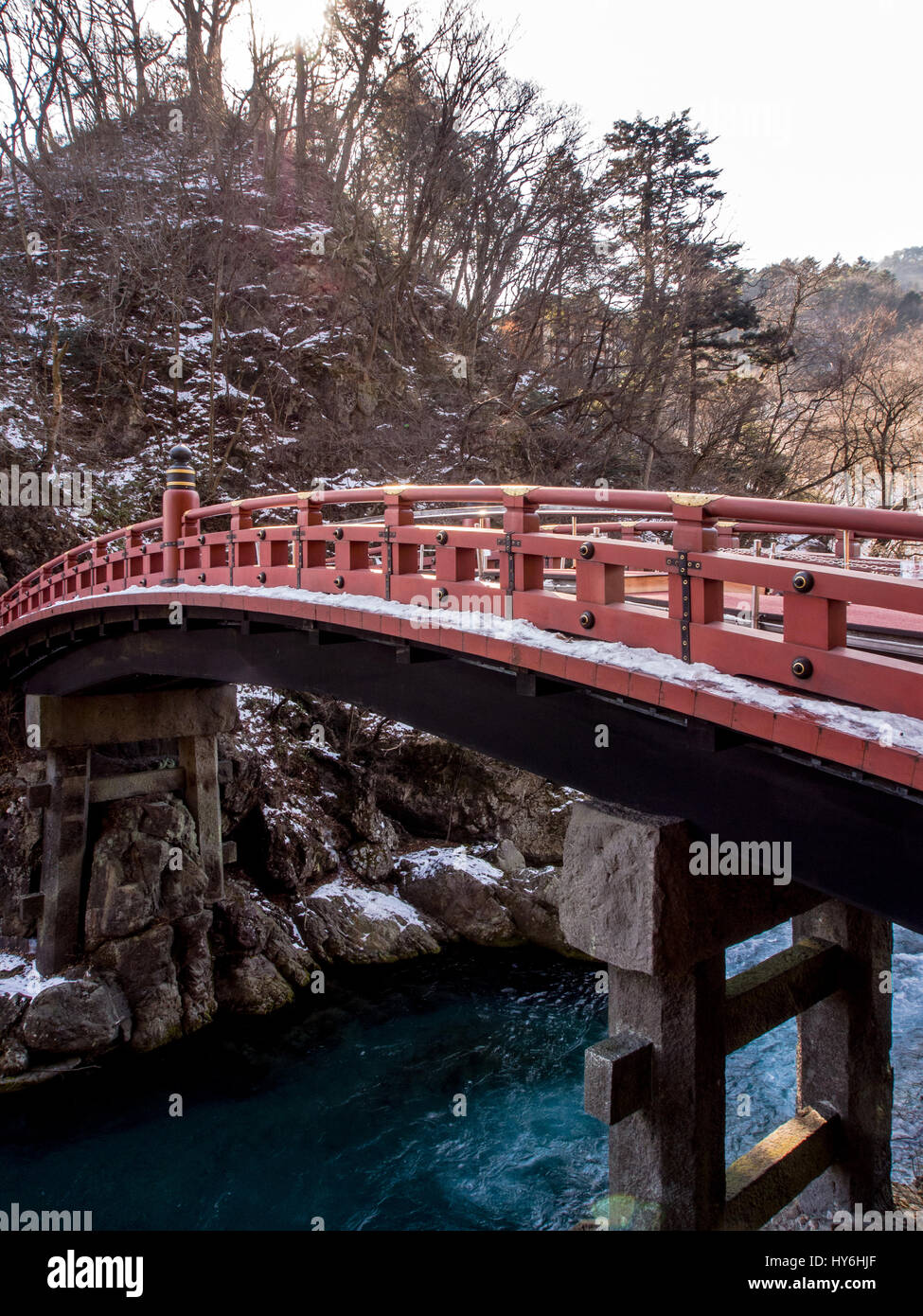 Snow on the Shinkyo sacred bridge, a red lacquered span that arches gracefully across the Daiya River. Nikko, Tochigi, Japan. Winter. Stock Photo