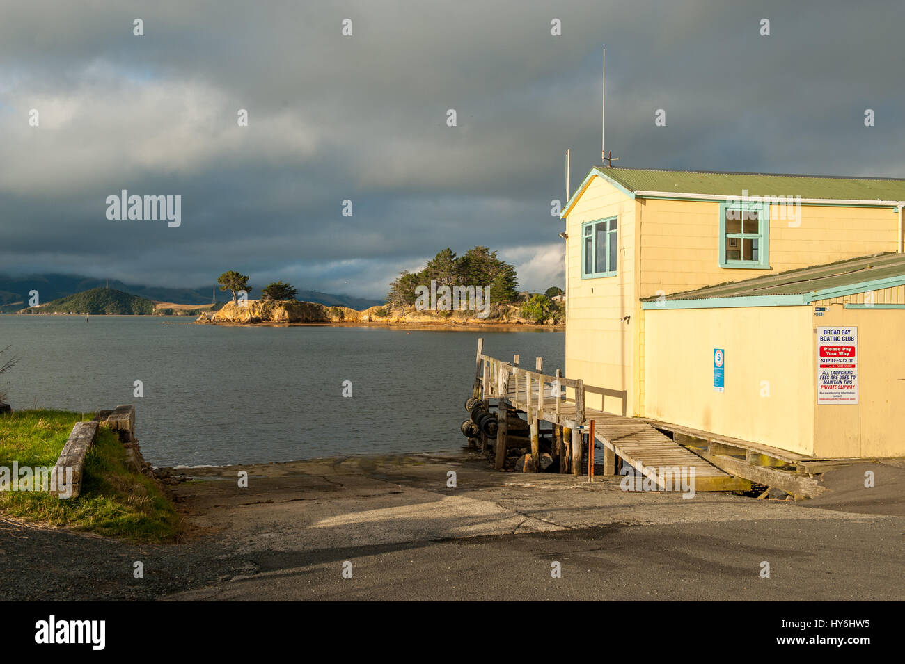 Boat houses at Otago Peninsula and Otago Harbour during sunset east of Dunedin, New Zealand Stock Photo